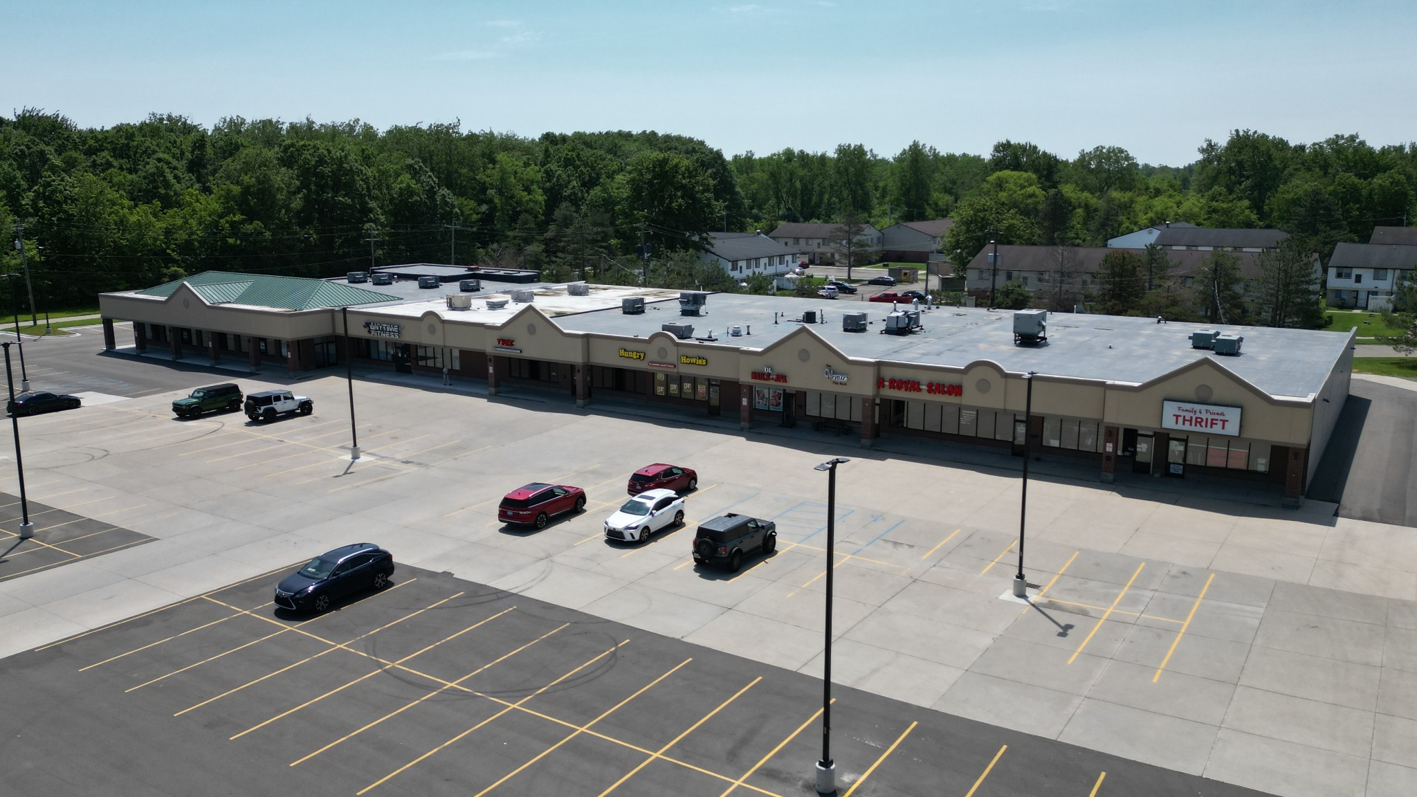 Later aerial view of the retail center with a finished parking lot and more active storefronts